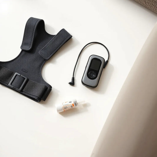Posture corrector brace and compact handheld nebulizer set on a clean neutral background